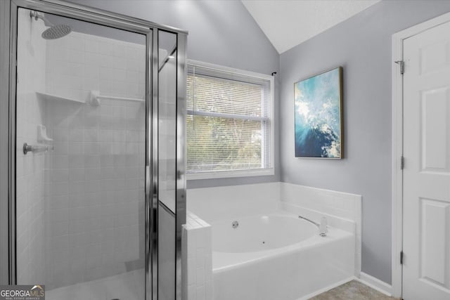 bathroom with lofted ceiling, a garden tub, a shower stall, and baseboards