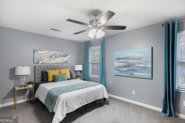 bedroom featuring carpet floors, visible vents, and baseboards