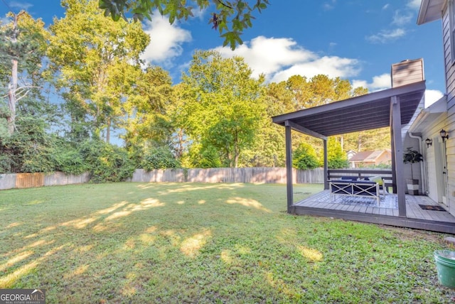 view of yard featuring a fenced backyard and a deck