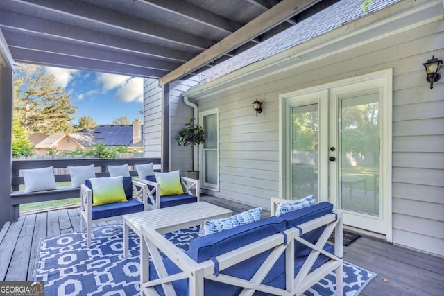 wooden terrace featuring an outdoor living space