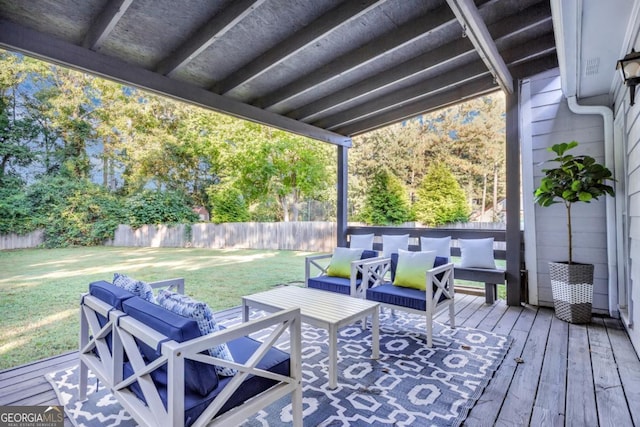 wooden terrace with a lawn, outdoor lounge area, and a fenced backyard