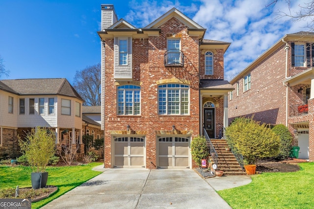 view of front of house featuring a garage, brick siding, concrete driveway, a chimney, and a front yard