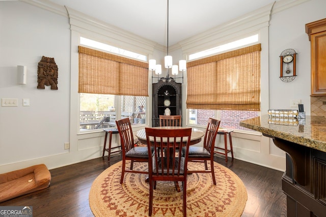 dining space with dark wood-style floors and crown molding