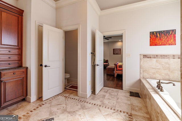 full bath featuring baseboards, toilet, ornamental molding, ensuite bathroom, and a garden tub