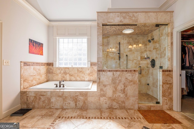 bathroom featuring a garden tub, vaulted ceiling, a spacious closet, ornamental molding, and a stall shower