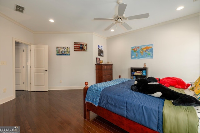 bedroom featuring baseboards, visible vents, wood finished floors, and ornamental molding