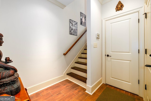 stairs featuring baseboards and wood finished floors