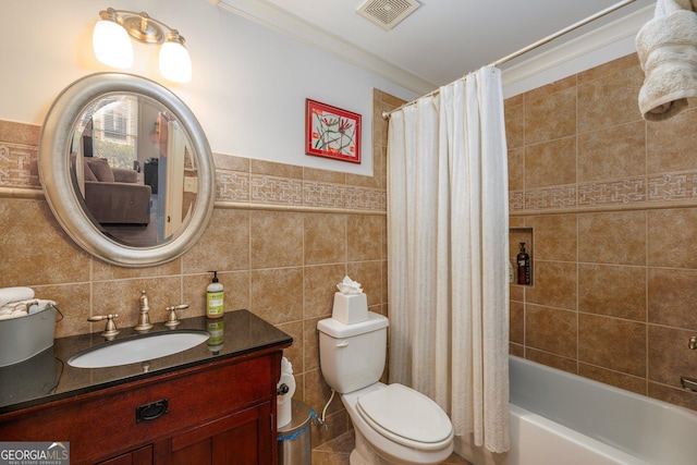 full bathroom with visible vents, toilet, shower / bathtub combination with curtain, vanity, and tile walls