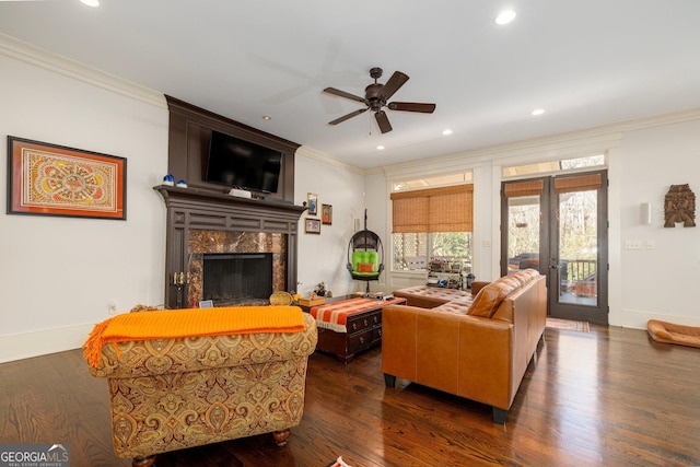 living room featuring ornamental molding, french doors, a premium fireplace, and dark wood-style floors