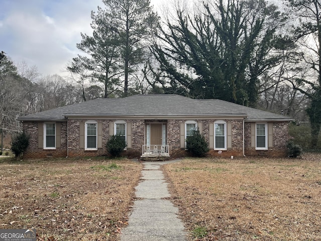 ranch-style home with brick siding, crawl space, and a shingled roof