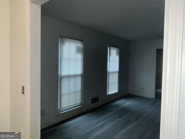 unfurnished room featuring dark wood-style floors