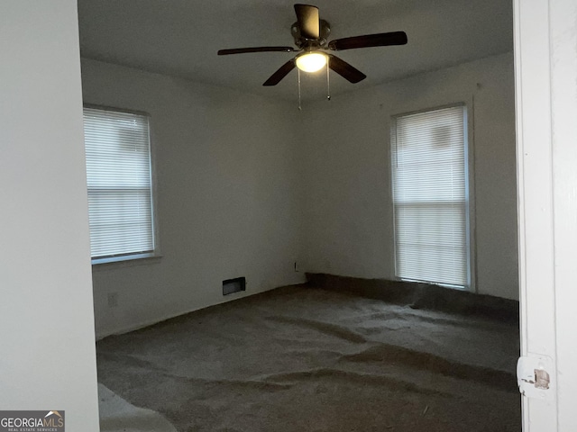 unfurnished room with ceiling fan, plenty of natural light, and carpet flooring