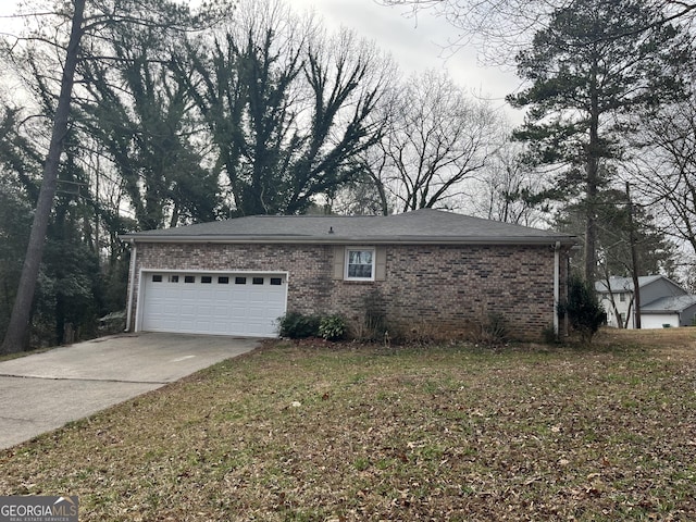 exterior space with driveway, a garage, and brick siding