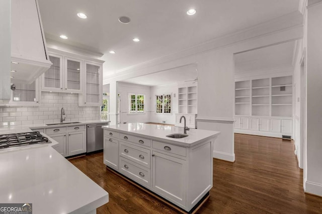 kitchen featuring stainless steel appliances, white cabinets, and a sink