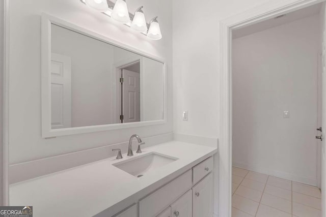 bathroom with tile patterned floors, baseboards, and vanity