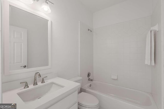 bathroom featuring toilet, vanity, and bathing tub / shower combination