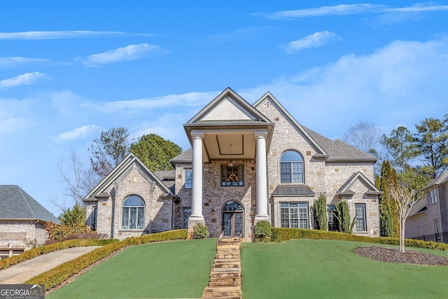 view of front of property with a standing seam roof, metal roof, a front lawn, and french doors