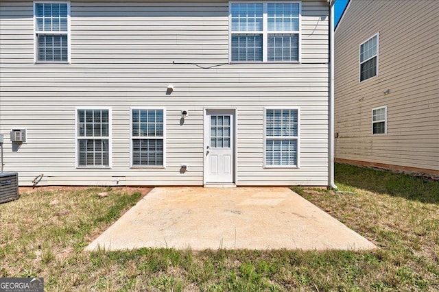 rear view of house with a yard and a patio