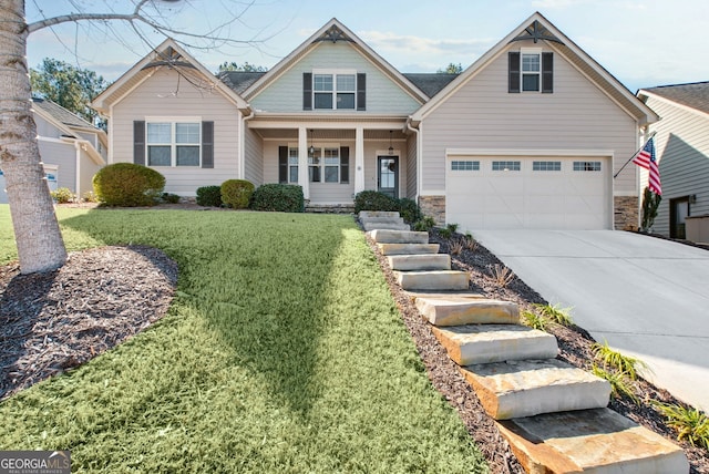 craftsman inspired home with a garage, stone siding, concrete driveway, and a front yard