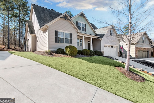 view of front of house featuring a garage, a front yard, concrete driveway, and a shingled roof