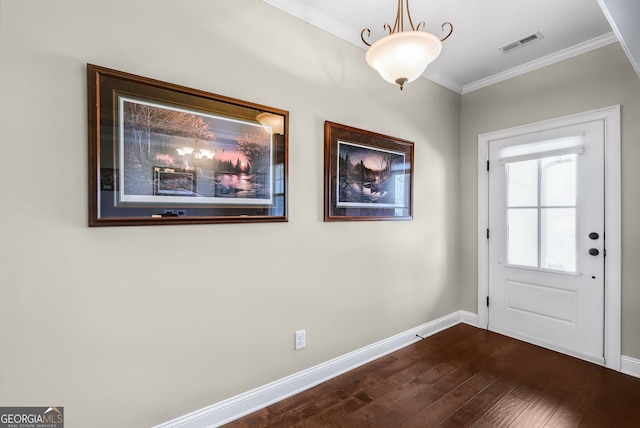 doorway featuring dark wood finished floors, visible vents, crown molding, and baseboards