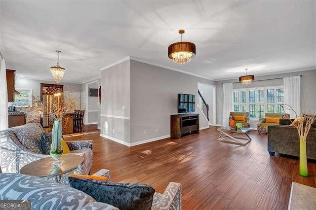 living room featuring a chandelier, wood finished floors, and ornamental molding