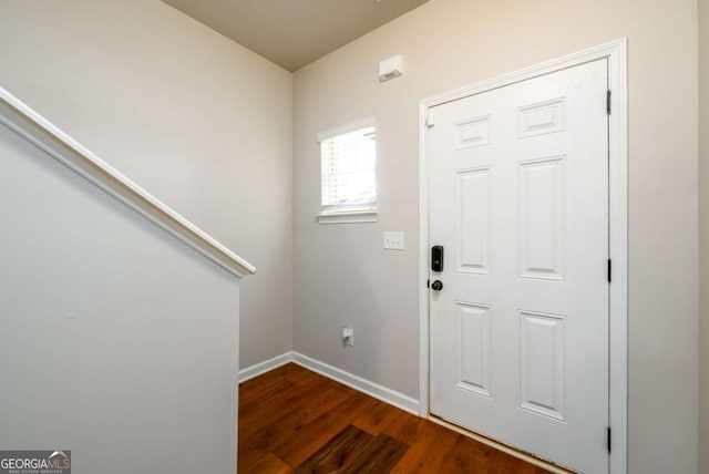 entrance foyer featuring dark wood finished floors and baseboards