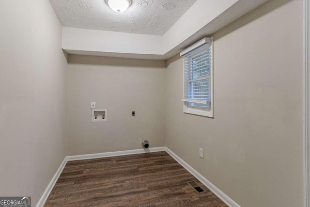 clothes washing area with hookup for a washing machine, laundry area, dark wood-type flooring, baseboards, and electric dryer hookup