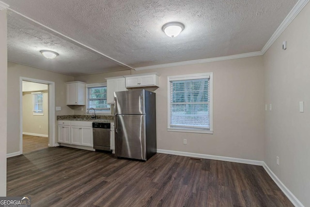 kitchen with baseboards, dark wood finished floors, stainless steel appliances, crown molding, and white cabinetry