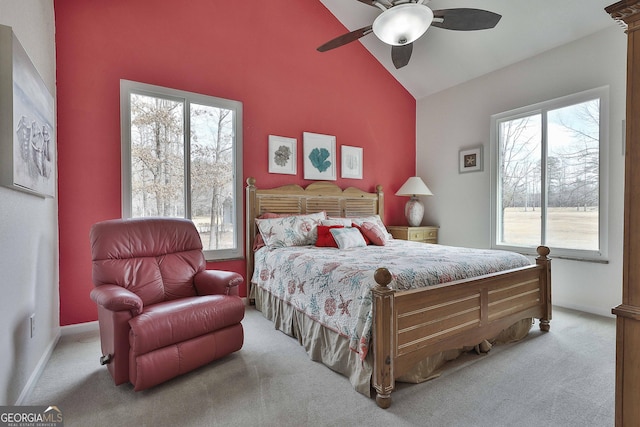 bedroom with lofted ceiling, ceiling fan, light carpet, and baseboards