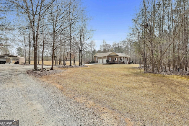 view of front of property with driveway, a front lawn, and an attached garage