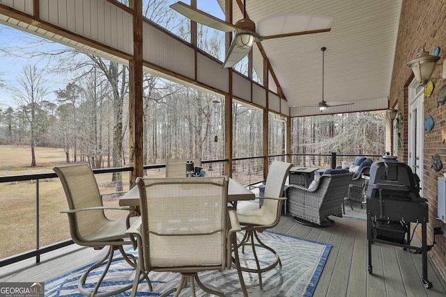 sunroom / solarium with a ceiling fan