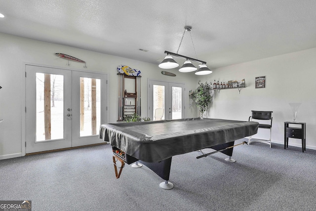 rec room with carpet, baseboards, a textured ceiling, and french doors