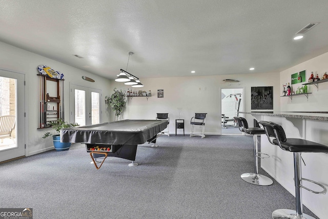 game room featuring a textured ceiling, recessed lighting, visible vents, baseboards, and french doors