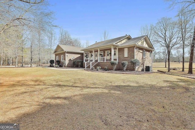 view of home's exterior with brick siding, a yard, and central air condition unit