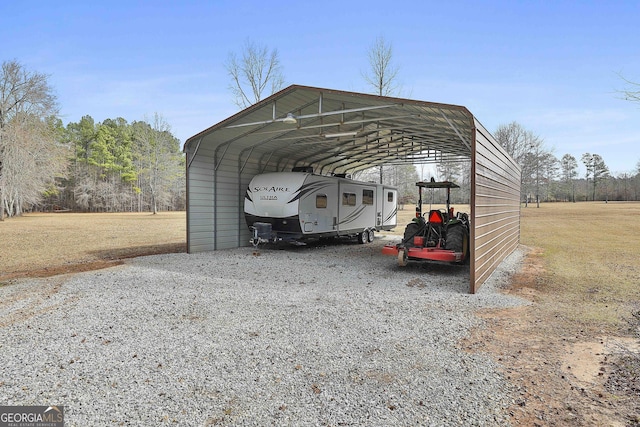 view of car parking with a carport and gravel driveway