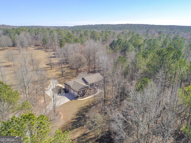 aerial view featuring a wooded view