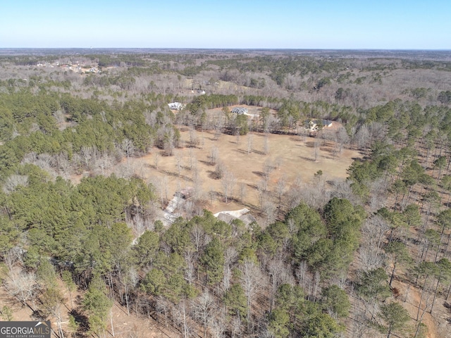 drone / aerial view featuring a forest view