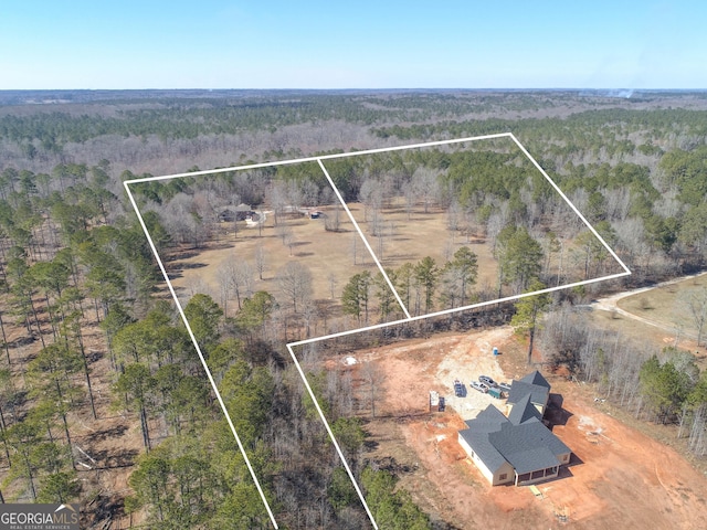 birds eye view of property featuring a rural view and a view of trees