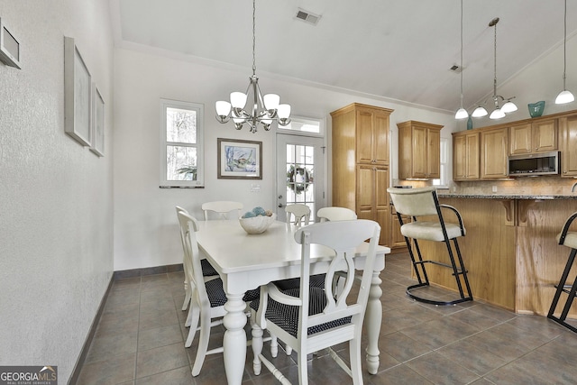 dining area with high vaulted ceiling, a notable chandelier, dark tile patterned floors, visible vents, and baseboards