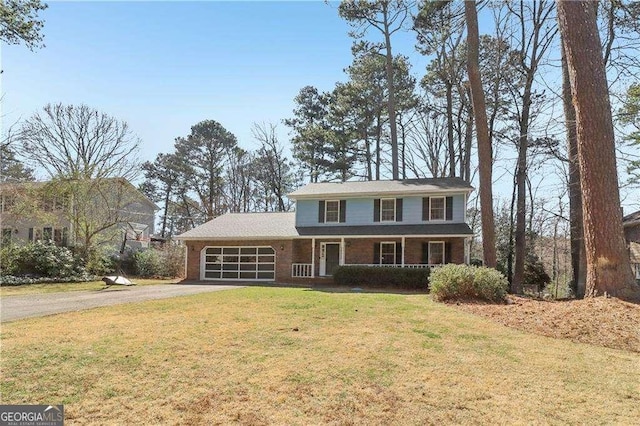 view of front facade featuring a porch, a front yard, driveway, and an attached garage