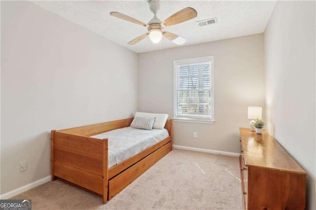 bedroom with carpet floors, visible vents, baseboards, and ceiling fan