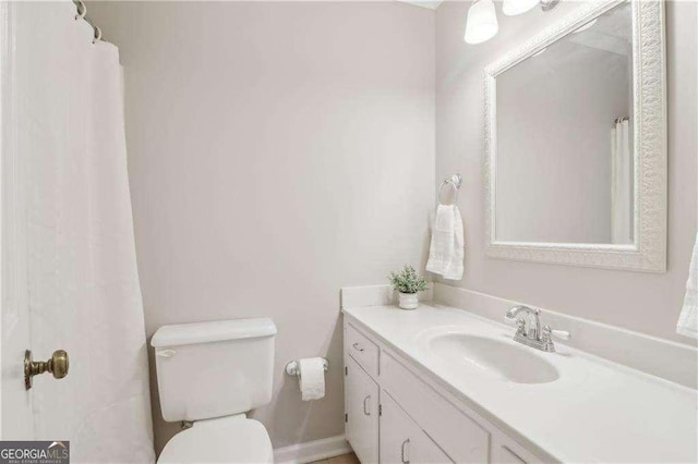 bathroom with toilet and vanity