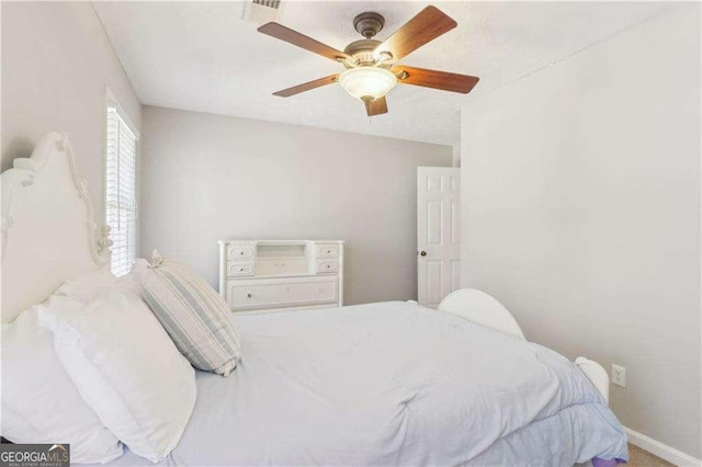 bedroom featuring a ceiling fan and baseboards