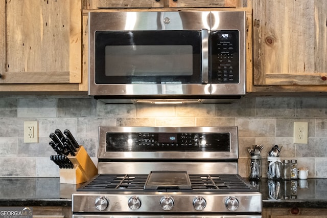 kitchen featuring appliances with stainless steel finishes and decorative backsplash