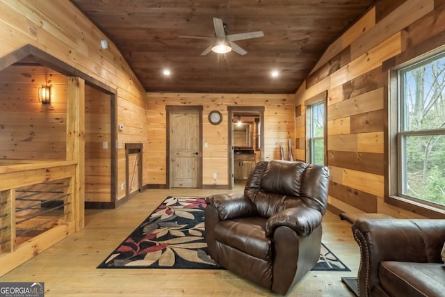 living area featuring wooden ceiling, a wealth of natural light, vaulted ceiling, and wood finished floors