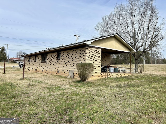 view of property exterior featuring a yard and brick siding