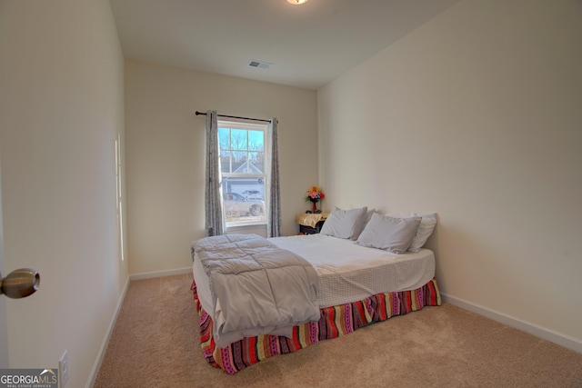 carpeted bedroom featuring visible vents and baseboards