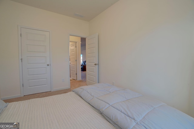 bedroom featuring carpet flooring and baseboards