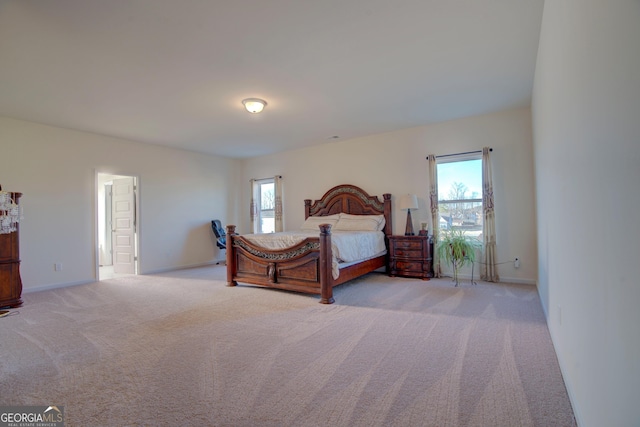 bedroom featuring baseboards and light colored carpet